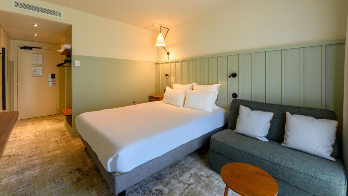 Un ou plusieurs lits dans un hébergement de l'établissement Kyriad Prestige Compiègne Hotel & Spa