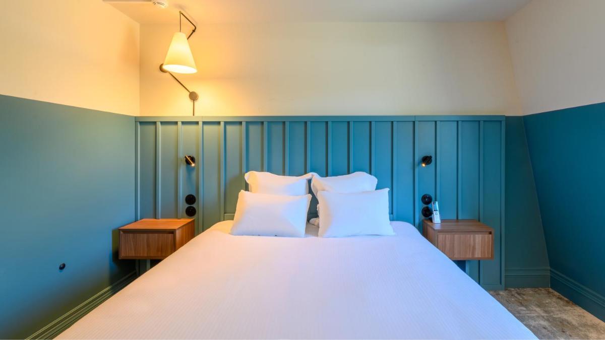 Un ou plusieurs lits dans un hébergement de l'établissement Kyriad Prestige Compiègne Hotel & Spa