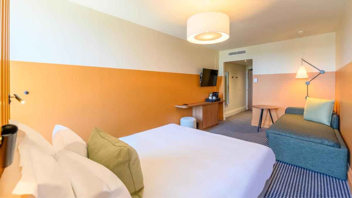 Un ou plusieurs lits dans un hébergement de l'établissement Kyriad Prestige Compiègne Hotel & Spa