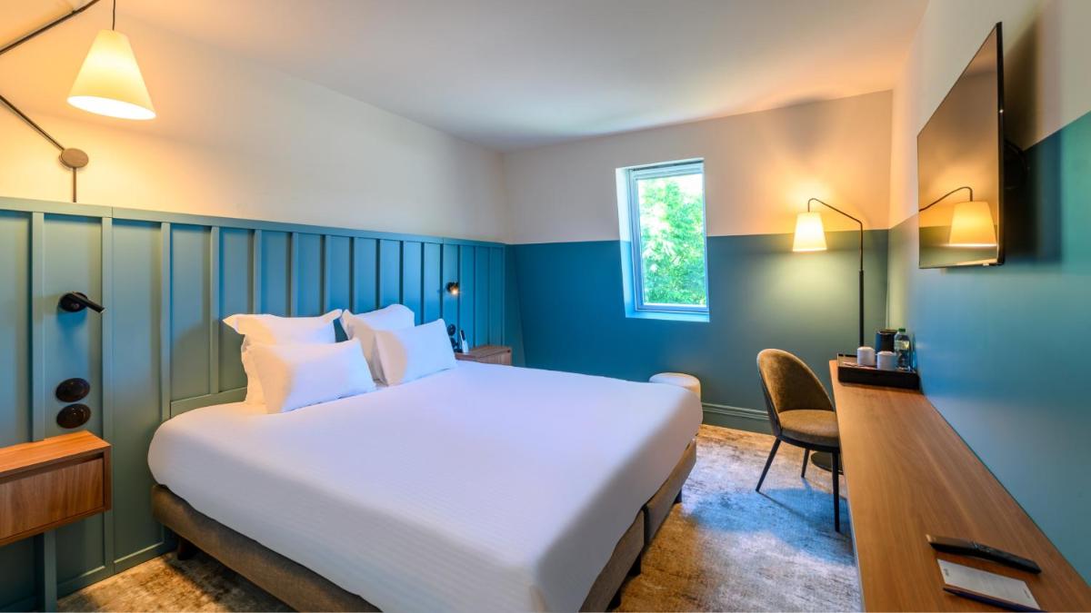 Un ou plusieurs lits dans un hébergement de l'établissement Kyriad Prestige Compiègne Hotel & Spa