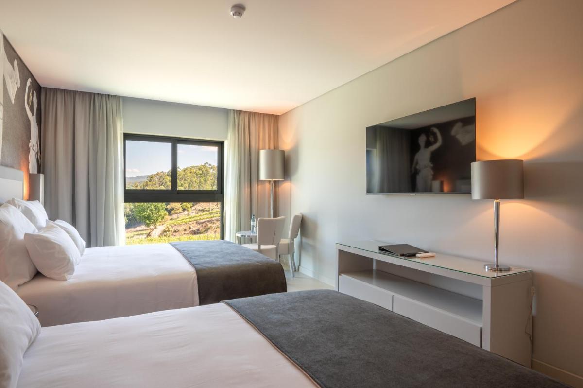 Uma cama ou camas num quarto em Vila Gale Collection Ponte de Lima