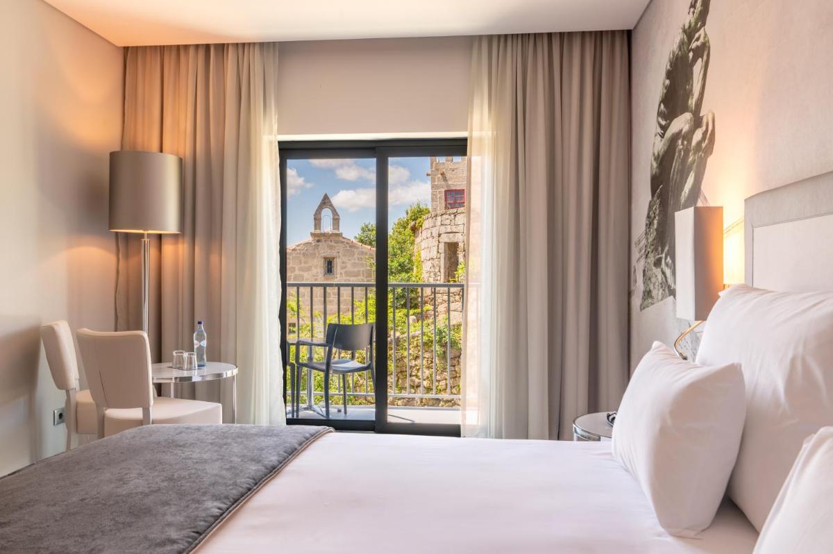 Uma cama ou camas num quarto em Vila Gale Collection Ponte de Lima