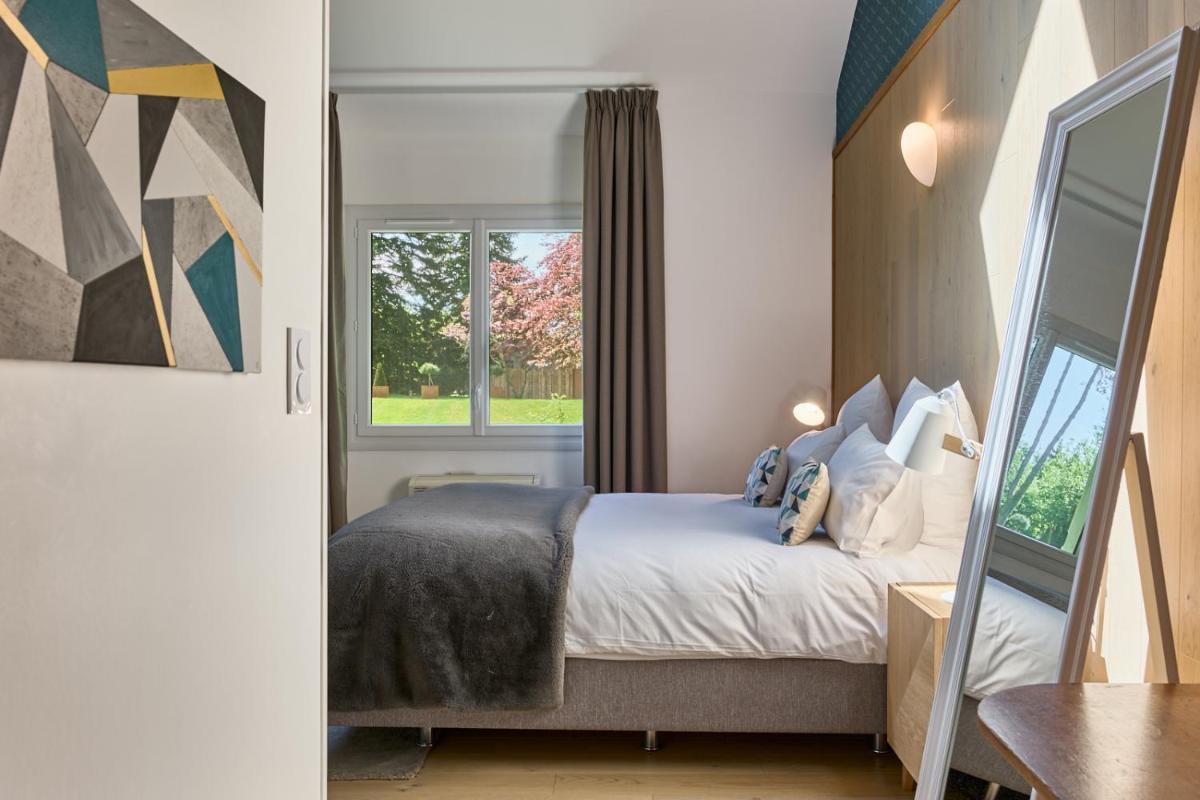 Un ou plusieurs lits dans un hébergement de l'établissement Maison Zugno Hôtel & Spa