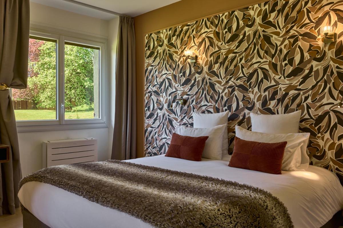 Un ou plusieurs lits dans un hébergement de l'établissement Maison Zugno Hôtel & Spa