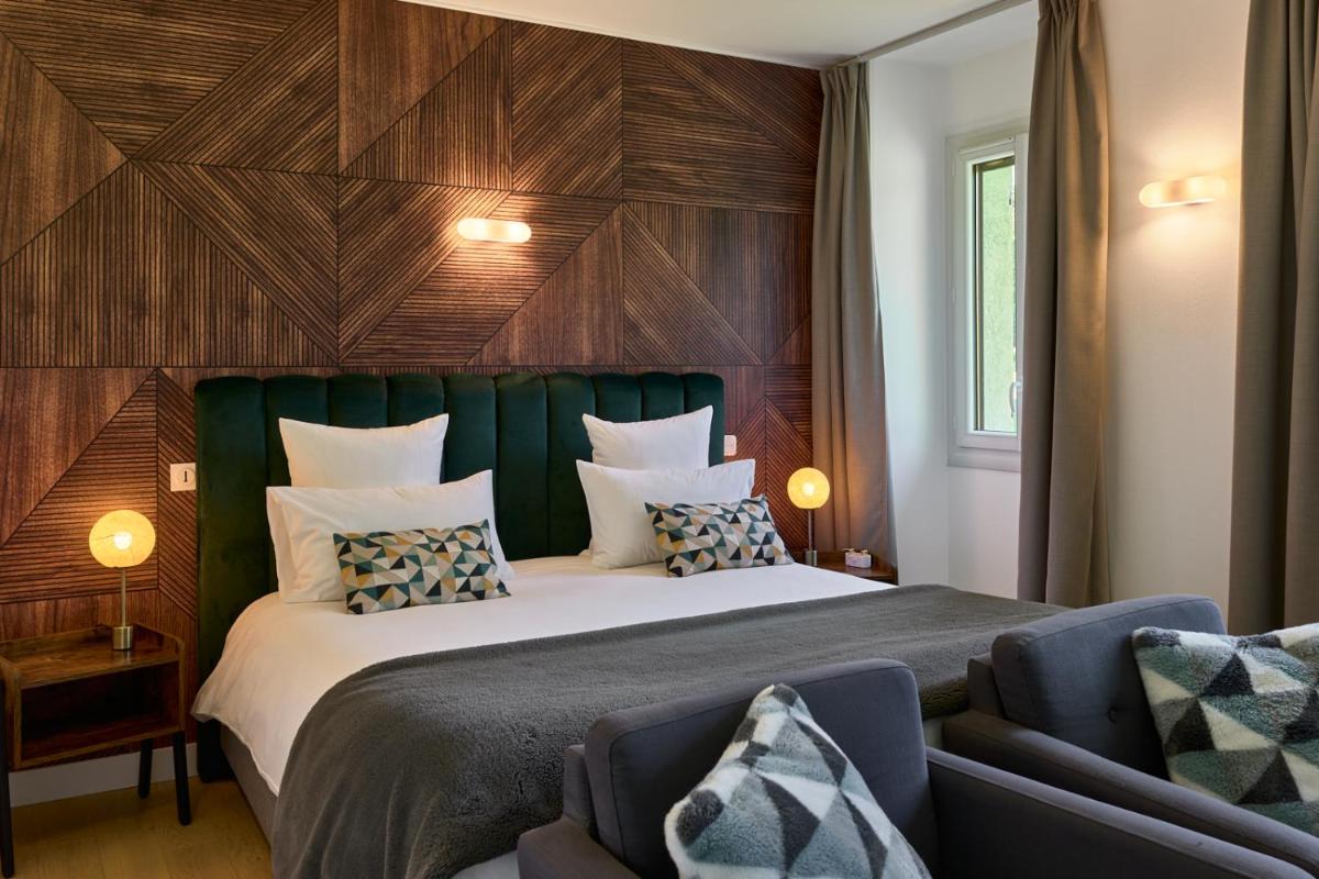 Un ou plusieurs lits dans un hébergement de l'établissement Maison Zugno Hôtel & Spa