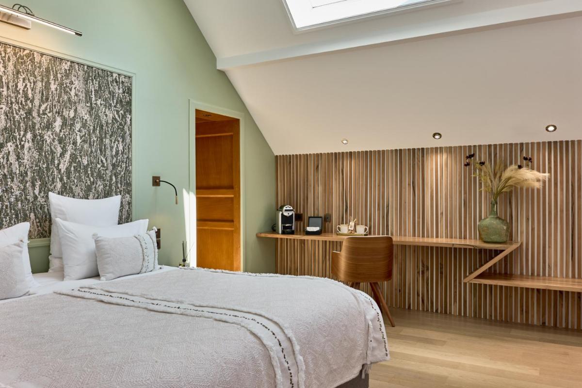 Un ou plusieurs lits dans un hébergement de l'établissement Maison Zugno Hôtel & Spa