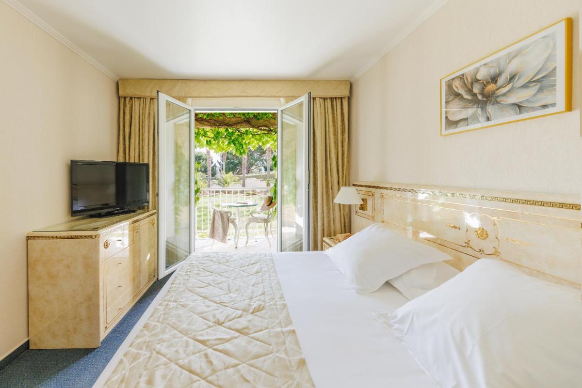 Un ou plusieurs lits dans un hébergement de l'établissement Hotel Corsica & Spa Serena