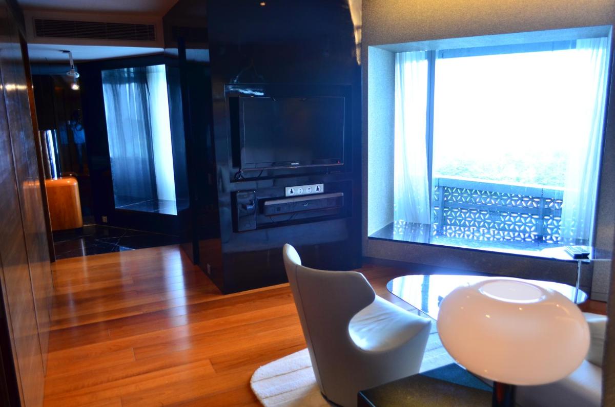 a room with a table and a chair and a window at The Park Hyderabad, Banjara Hills near Hussain Sagar Lake in Hyderabad a room with a table and a chair and a window at The Park Hyderabad, Banjara Hills near Hussain Sagar Lake in Hyderabad