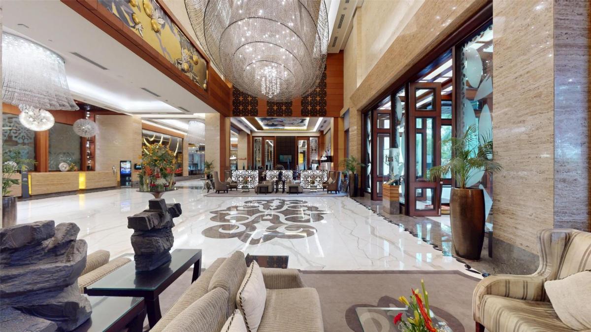 a lobby of a building with couches and chairs at Radisson Blu Hotel, Nagpur in Nagpur