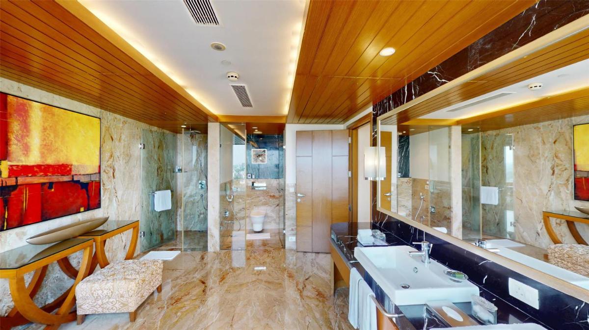 a large bathroom with a sink and a shower at Radisson Blu Hotel, Nagpur in Nagpur