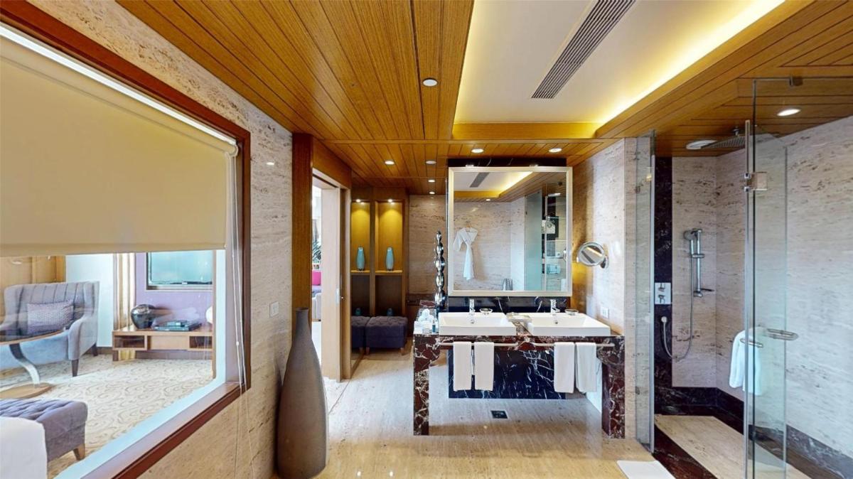a bathroom with a sink and a shower at Radisson Blu Hotel, Nagpur in Nagpur