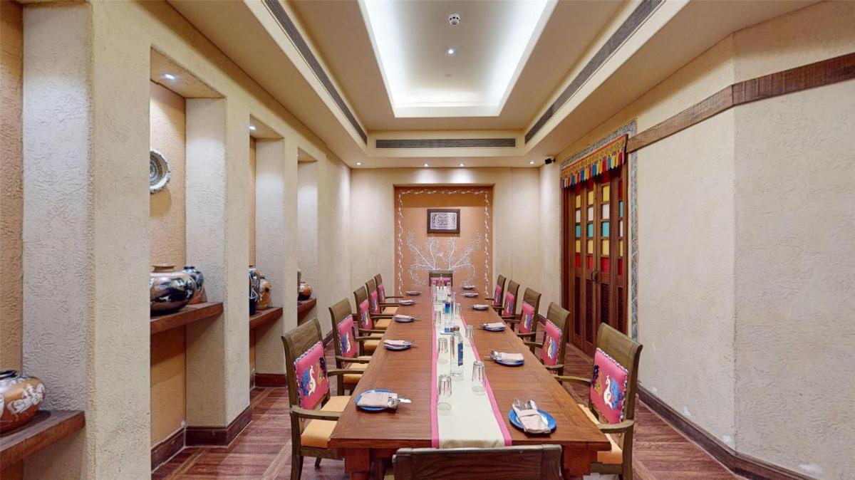 a long dining room with a long table and chairs at Radisson Blu Hotel, Nagpur in Nagpur