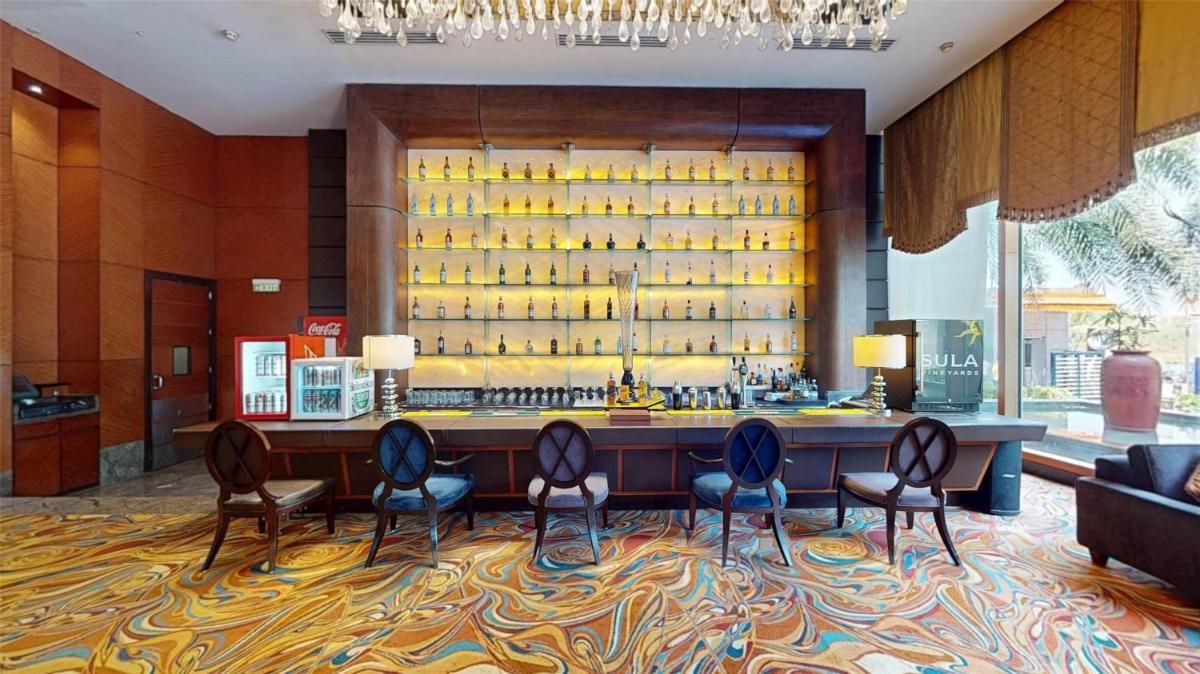 a lobby with a bar with a lot of wine bottles at Radisson Blu Hotel, Nagpur in Nagpur