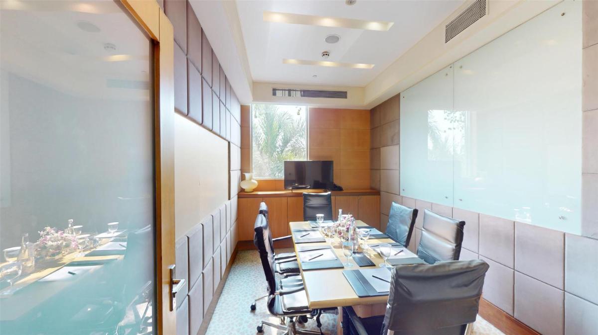 a dining room with a long table and chairs at Radisson Blu Hotel, Nagpur in Nagpur