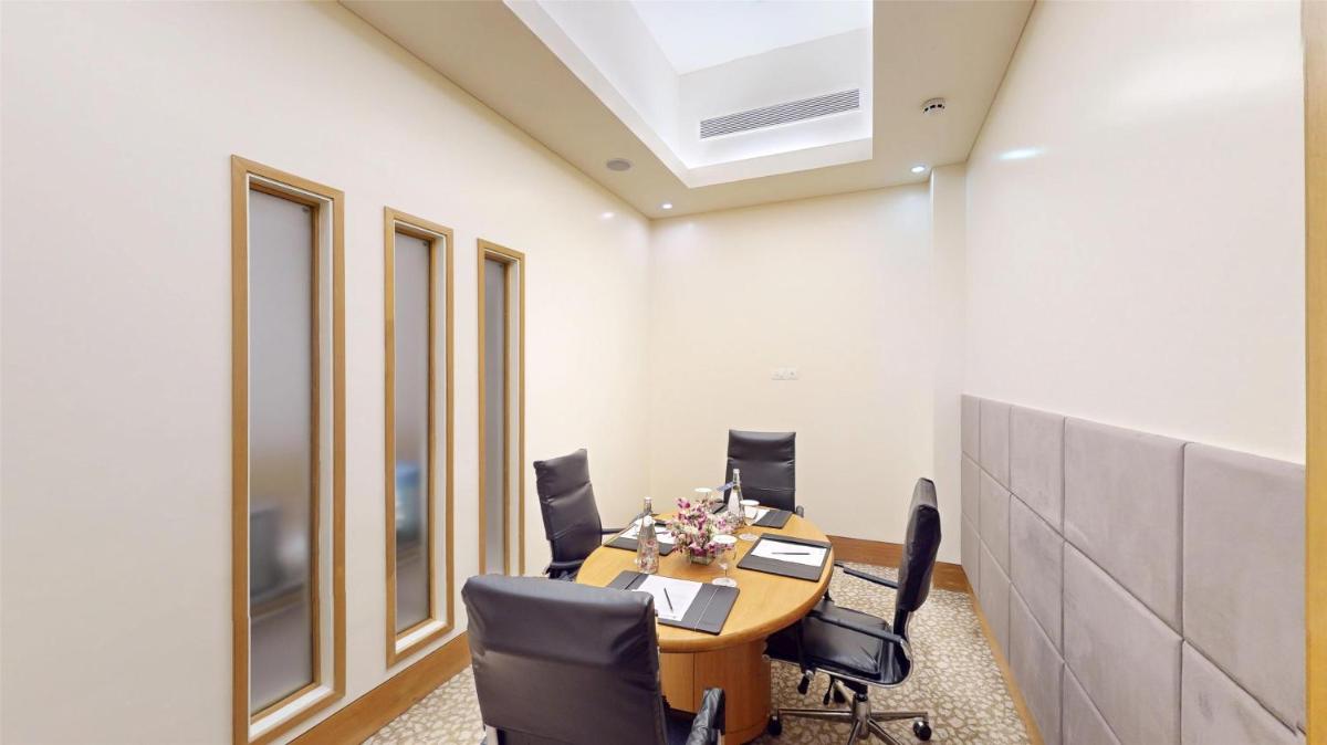 an office with a conference room with a table and chairs at Radisson Blu Hotel, Nagpur in Nagpur