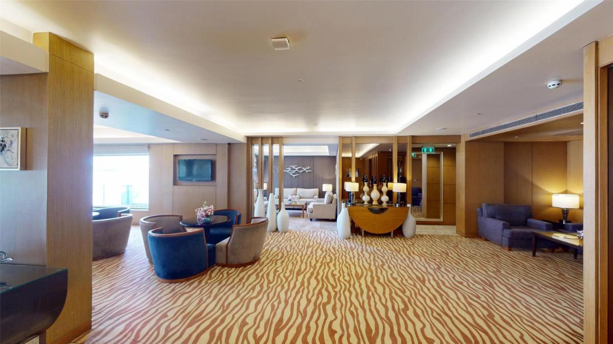 a hotel room with a large living room with furniture at Radisson Blu Hotel, Nagpur in Nagpur