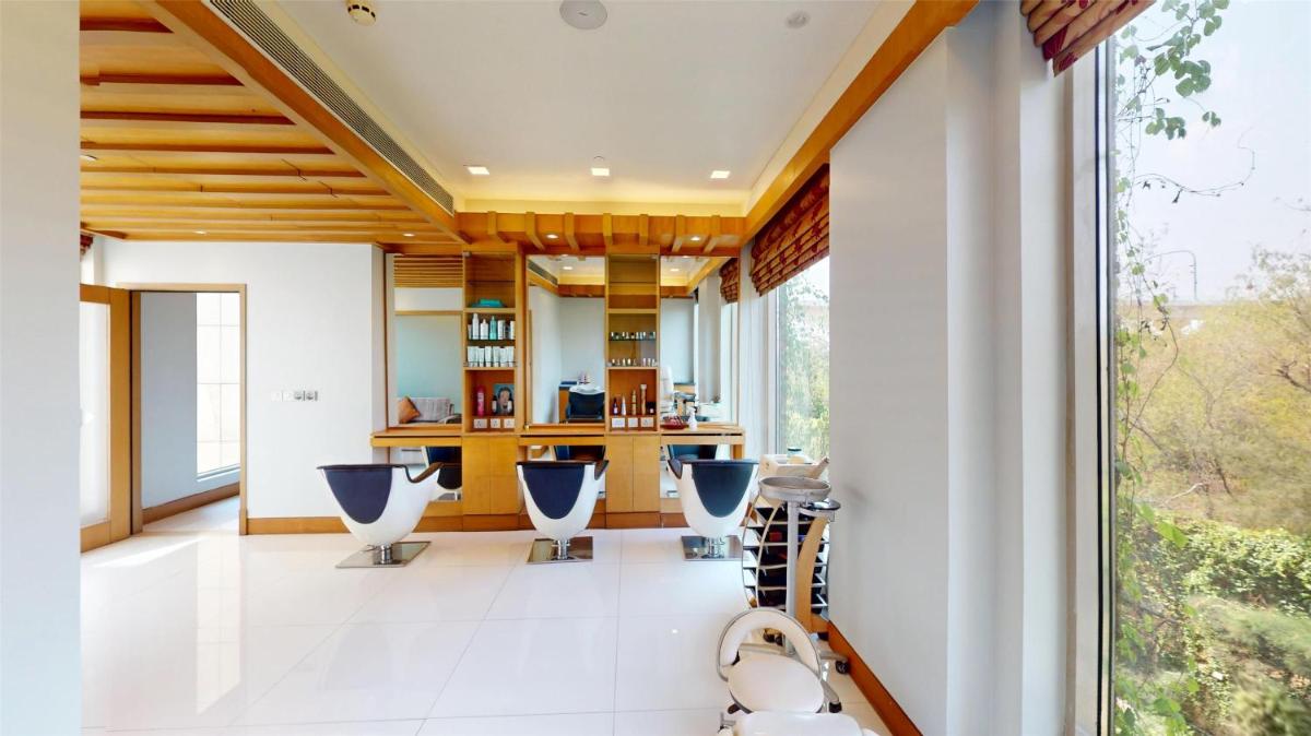 an open kitchen with blue chairs in a house at Radisson Blu Hotel, Nagpur in Nagpur