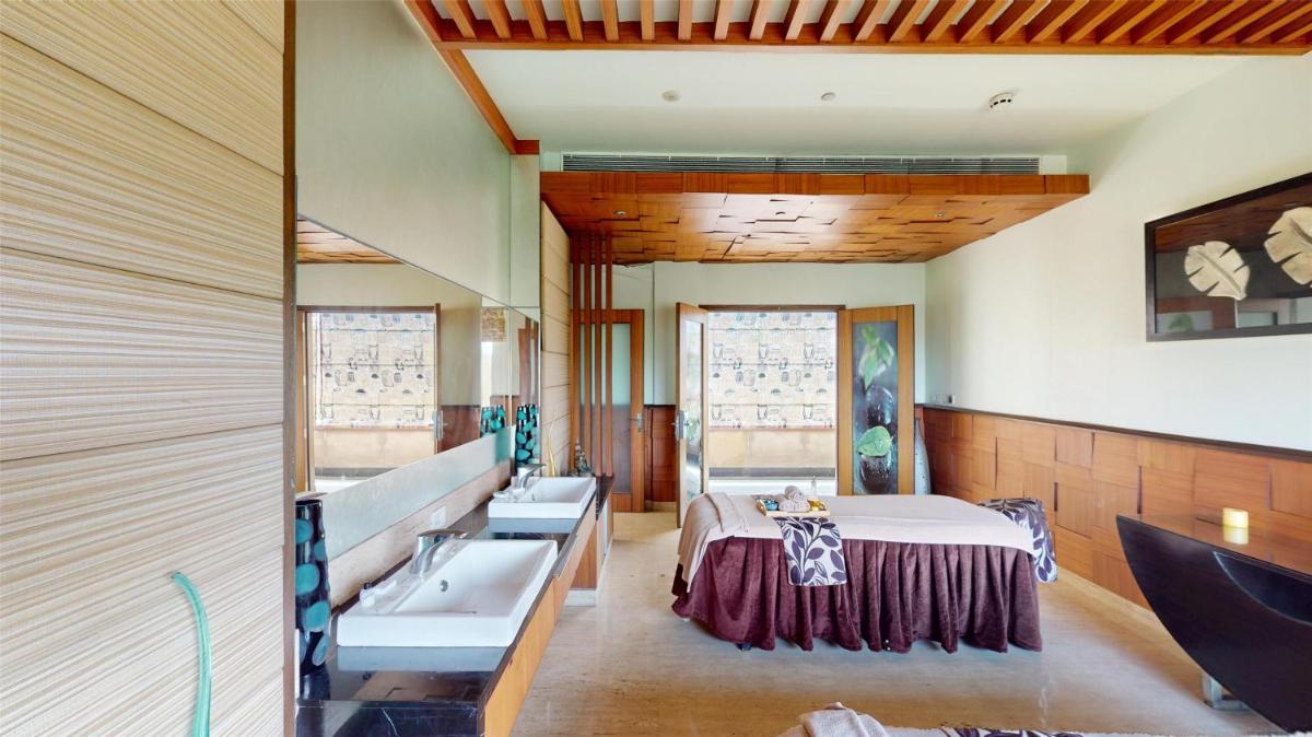 a room with two sinks and a bed in it at Radisson Blu Hotel, Nagpur in Nagpur