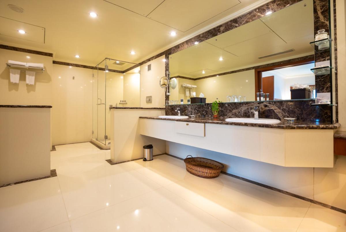 a bathroom with two sinks and a large mirror at The Orchid Hotel Mumbai Vile Parle in Mumbai