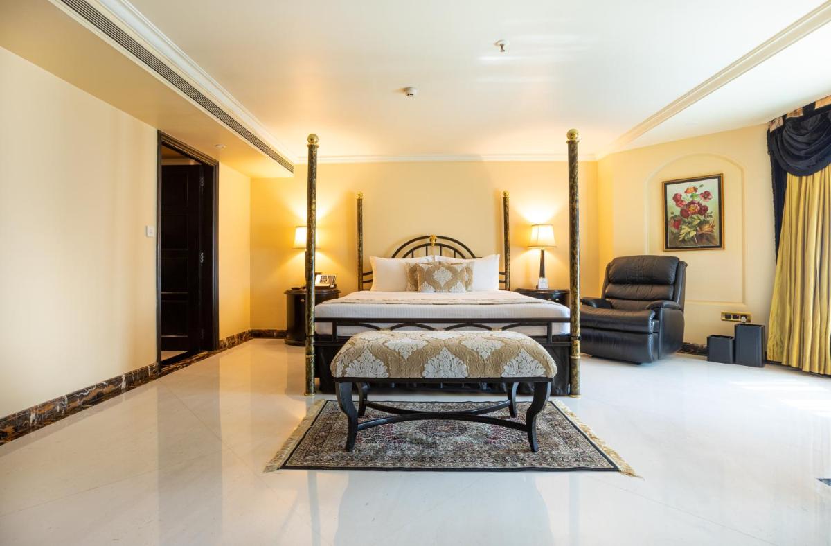 a bedroom with a bed and a chair at The Orchid Hotel Mumbai Vile Parle in Mumbai