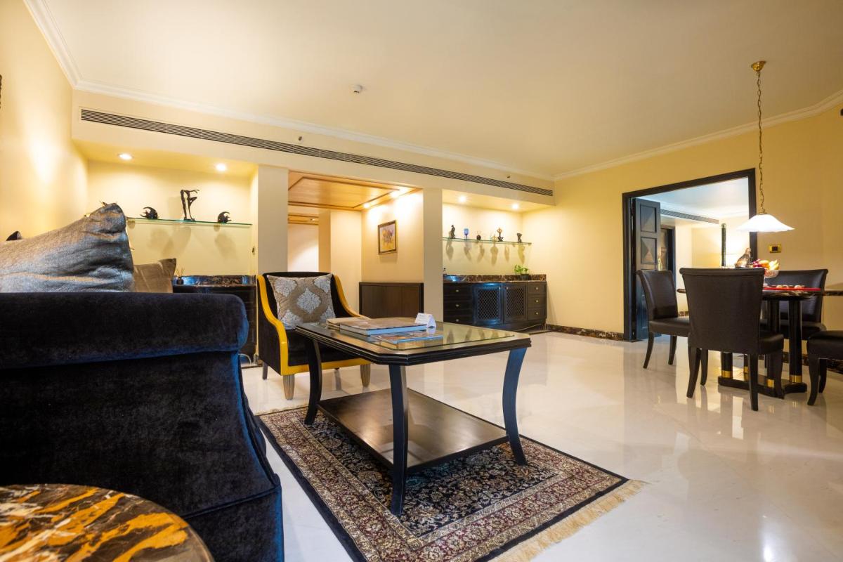 a living room with a couch and a table at The Orchid Hotel Mumbai Vile Parle in Mumbai