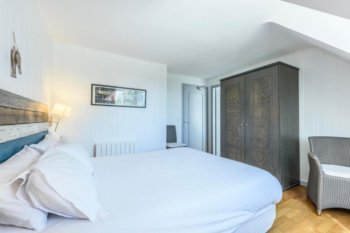 Un ou plusieurs lits dans un hébergement de l'établissement La Désirade - Hôtel, Spa & Restaurant