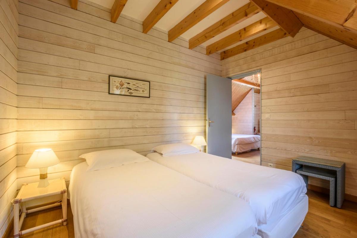 Un ou plusieurs lits dans un hébergement de l'établissement La Désirade - Hôtel, Spa & Restaurant