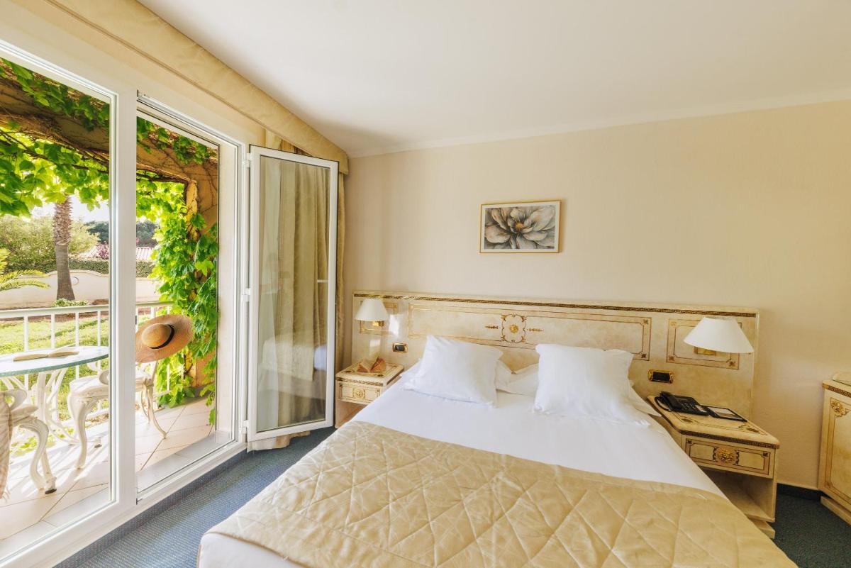Un ou plusieurs lits dans un hébergement de l'établissement Hotel Corsica & Spa Serena