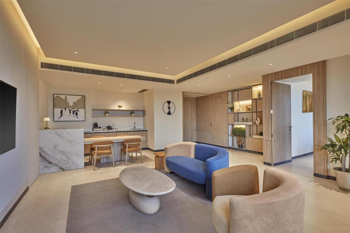 a living room with a blue couch and a table at Hilton Gurugram Baani City Centre in Gurgaon
