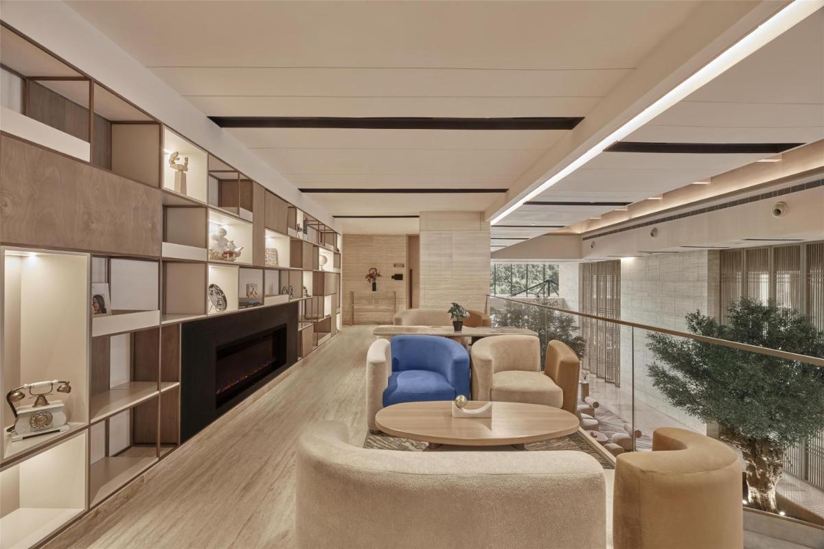 a living room with a couch and a table and chairs at Hilton Gurugram Baani City Centre in Gurgaon