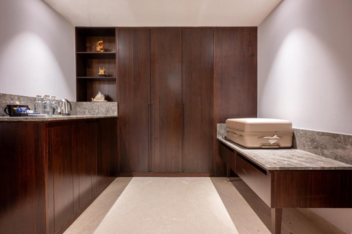 a kitchen with wooden walls and a counter with a appliance at Taj Deccan in Hyderabad a kitchen with wooden walls and a counter with a appliance at Taj Deccan in Hyderabad