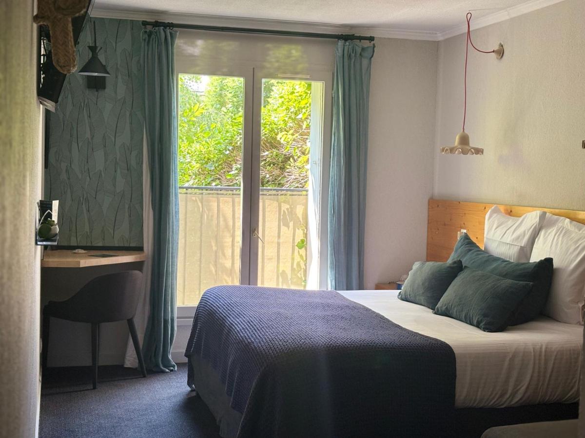Un ou plusieurs lits dans un hébergement de l'établissement Hotel Spa Azteca Barcelonnette
