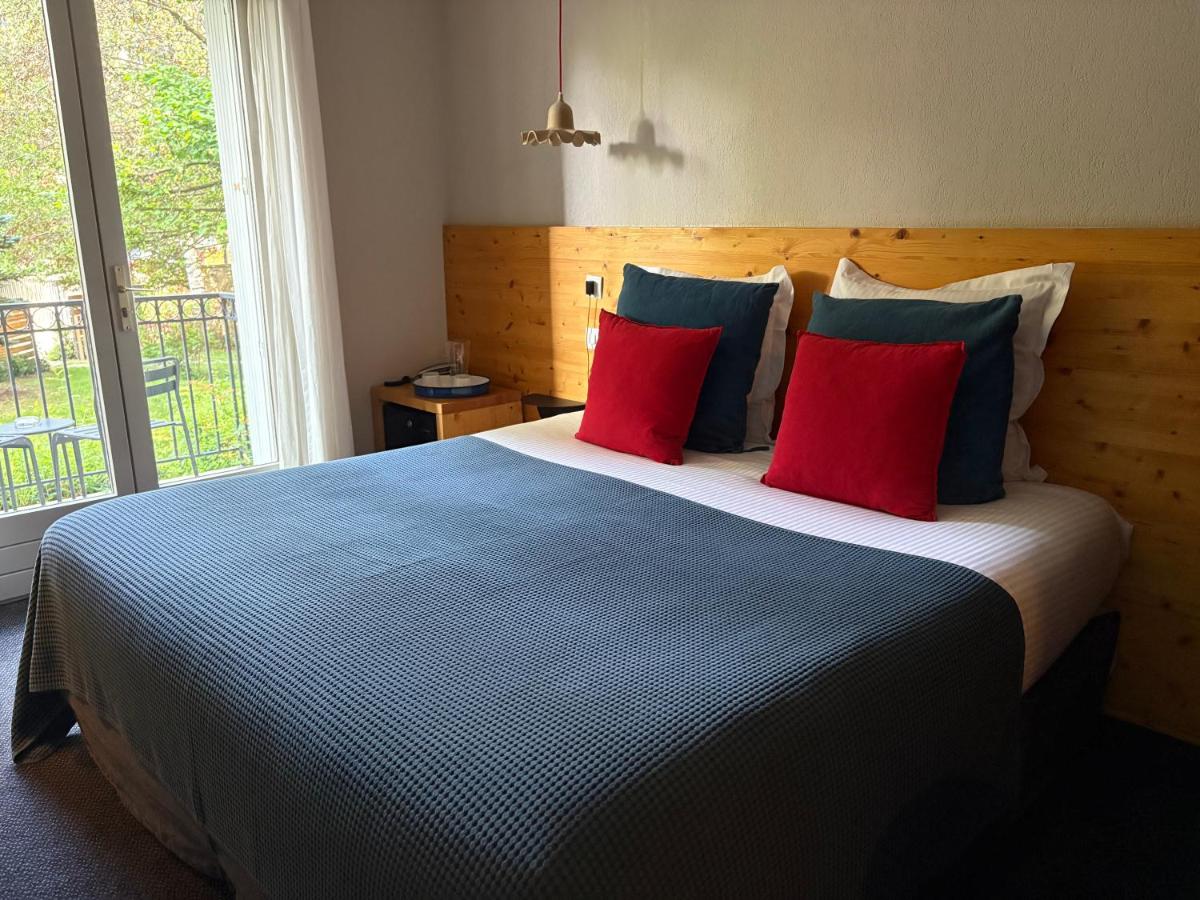 Un ou plusieurs lits dans un hébergement de l'établissement Hotel Spa Azteca Barcelonnette