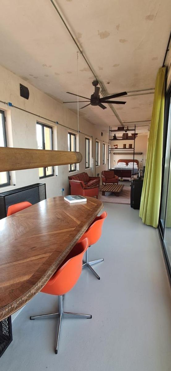 uma sala de conferências com uma mesa de madeira e cadeiras laranja em Moagem Industrial Lodge em Viana do Alentejo mais 130 fotografias