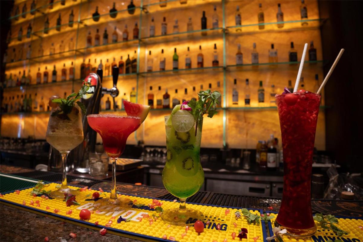 a group of four cocktails sitting on a bar at Radisson Blu Hotel, Nagpur in Nagpur
