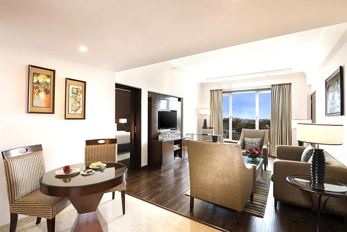 a living room with a couch and a table at Radisson Jaipur City Center in Jaipur