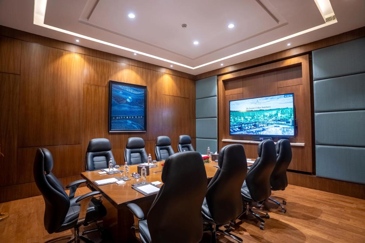 a conference room with a large table and chairs at The Leela Ambience Gurugram Hotel & Residences - The Luxury Urban Sanctuary in Gurgaon
