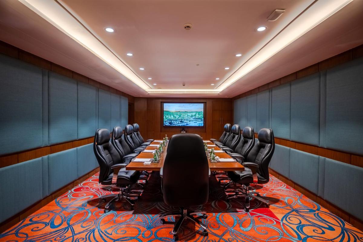 a conference room with a long table and chairs at The Leela Ambience Gurugram Hotel & Residences - The Luxury Urban Sanctuary in Gurgaon