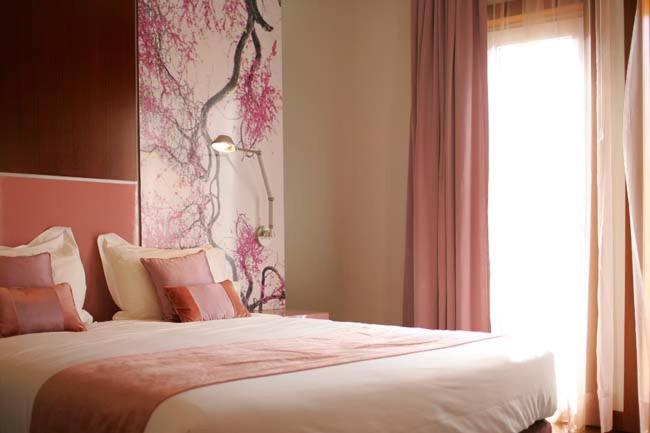 Uma cama ou camas num quarto em Hotel Quinta das Lagrimas - Small Luxury Hotels