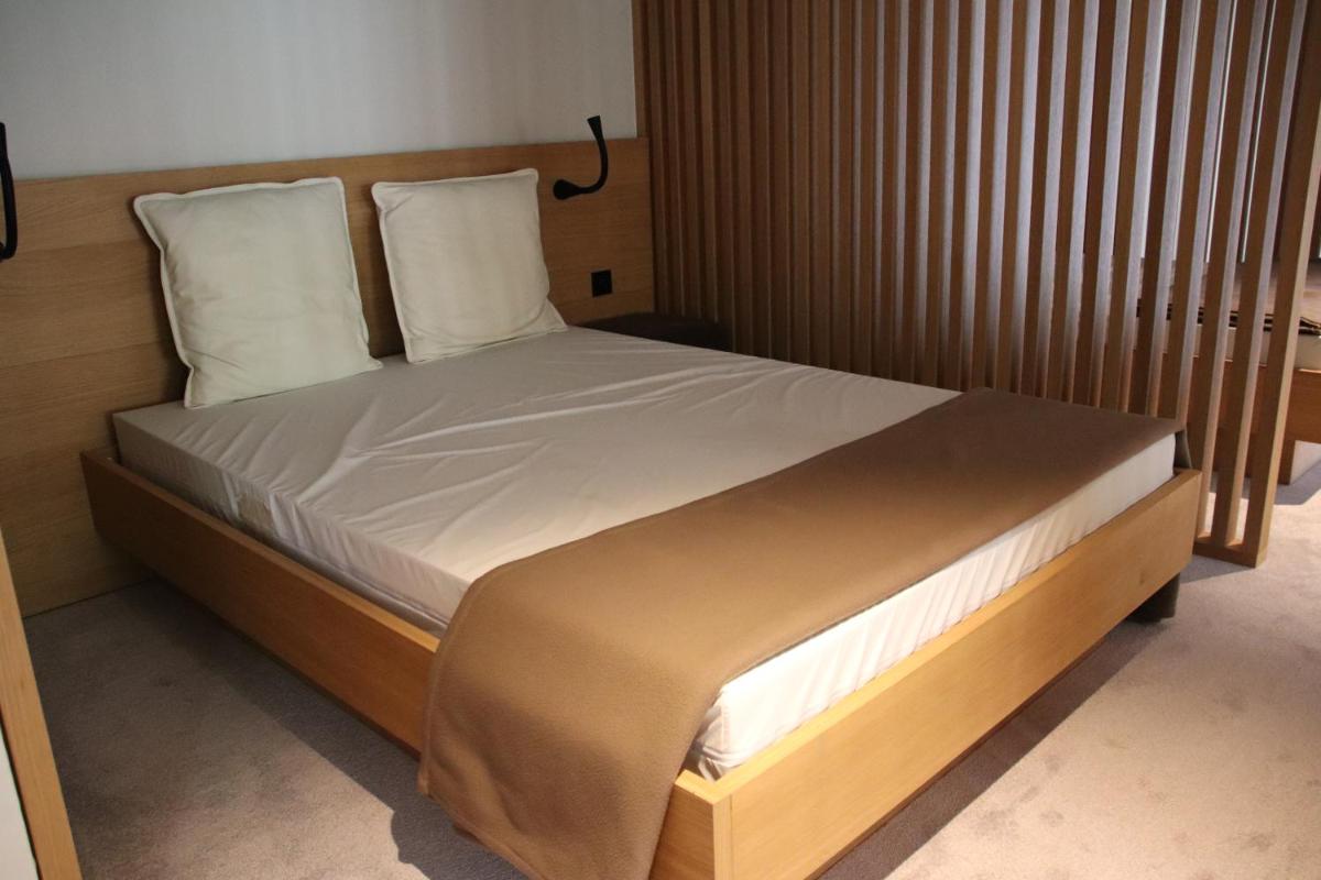 Un ou plusieurs lits dans un hébergement de l'établissement 6717 Nature Hôtel & Spa Le Clos des Délices