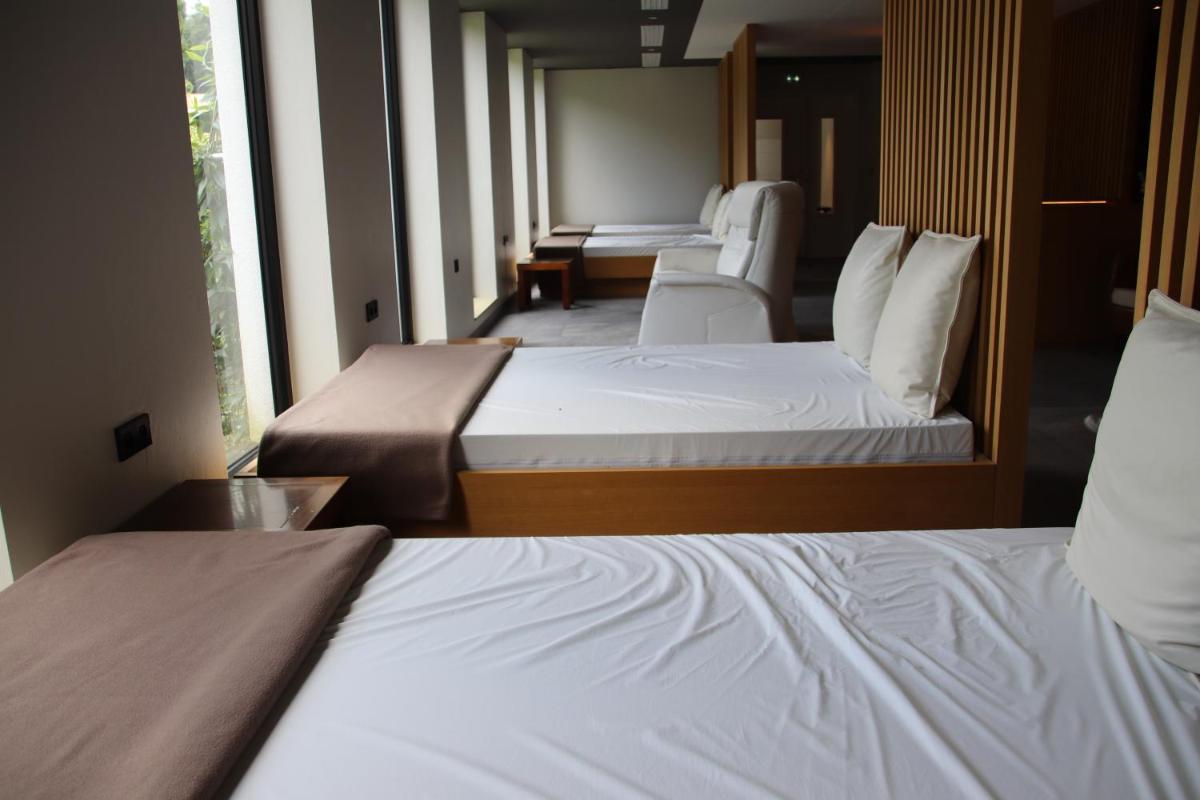 Un ou plusieurs lits dans un hébergement de l'établissement 6717 Nature Hôtel & Spa Le Clos des Délices
