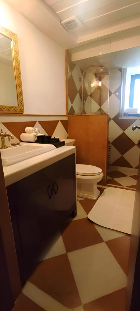 a bathroom with a sink and a toilet at The Postcard Cuelim, Goa in Cansaulim