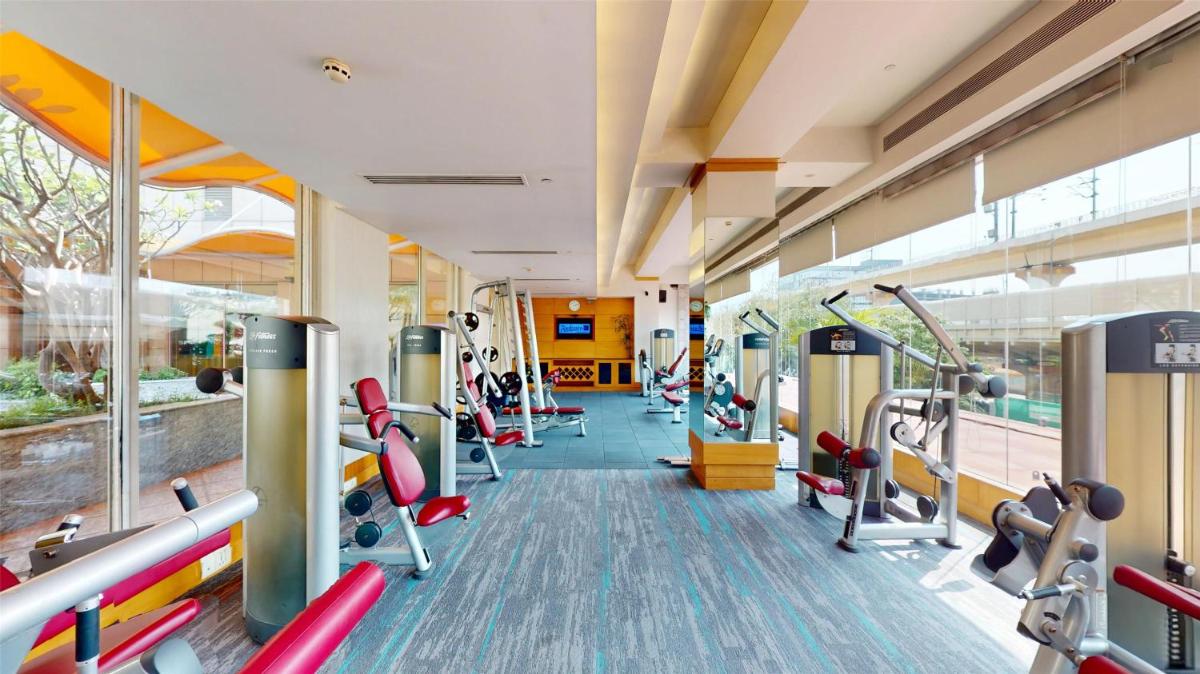 a gym with lots of treadmills and machines at Radisson Blu Hotel, Nagpur in Nagpur