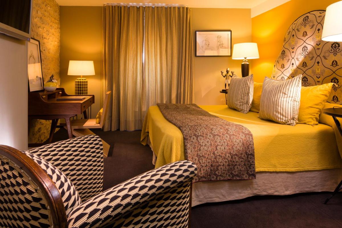 Un ou plusieurs lits dans un hébergement de l'établissement Hotel De France