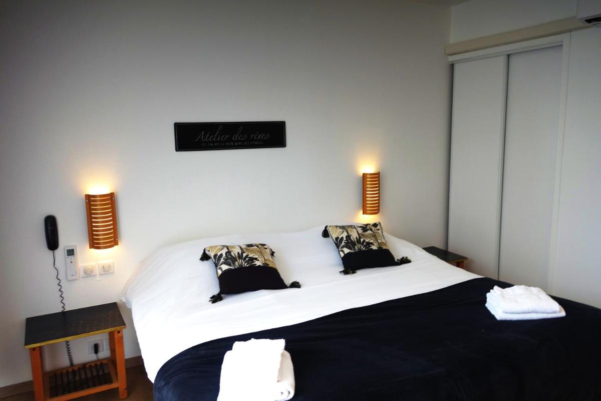Un ou plusieurs lits dans un hébergement de l'établissement Hôtel La Ségalière Spa Bar