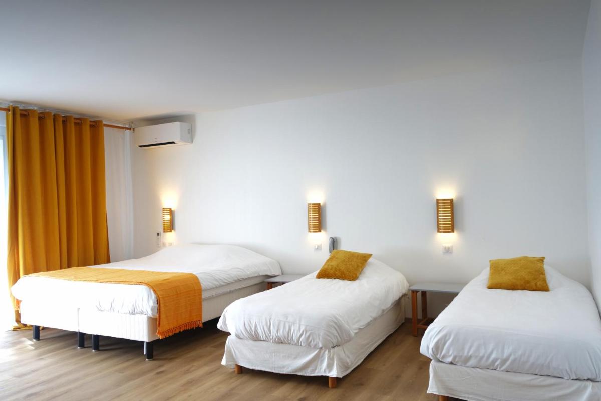 Un ou plusieurs lits dans un hébergement de l'établissement Hôtel La Ségalière Spa Bar