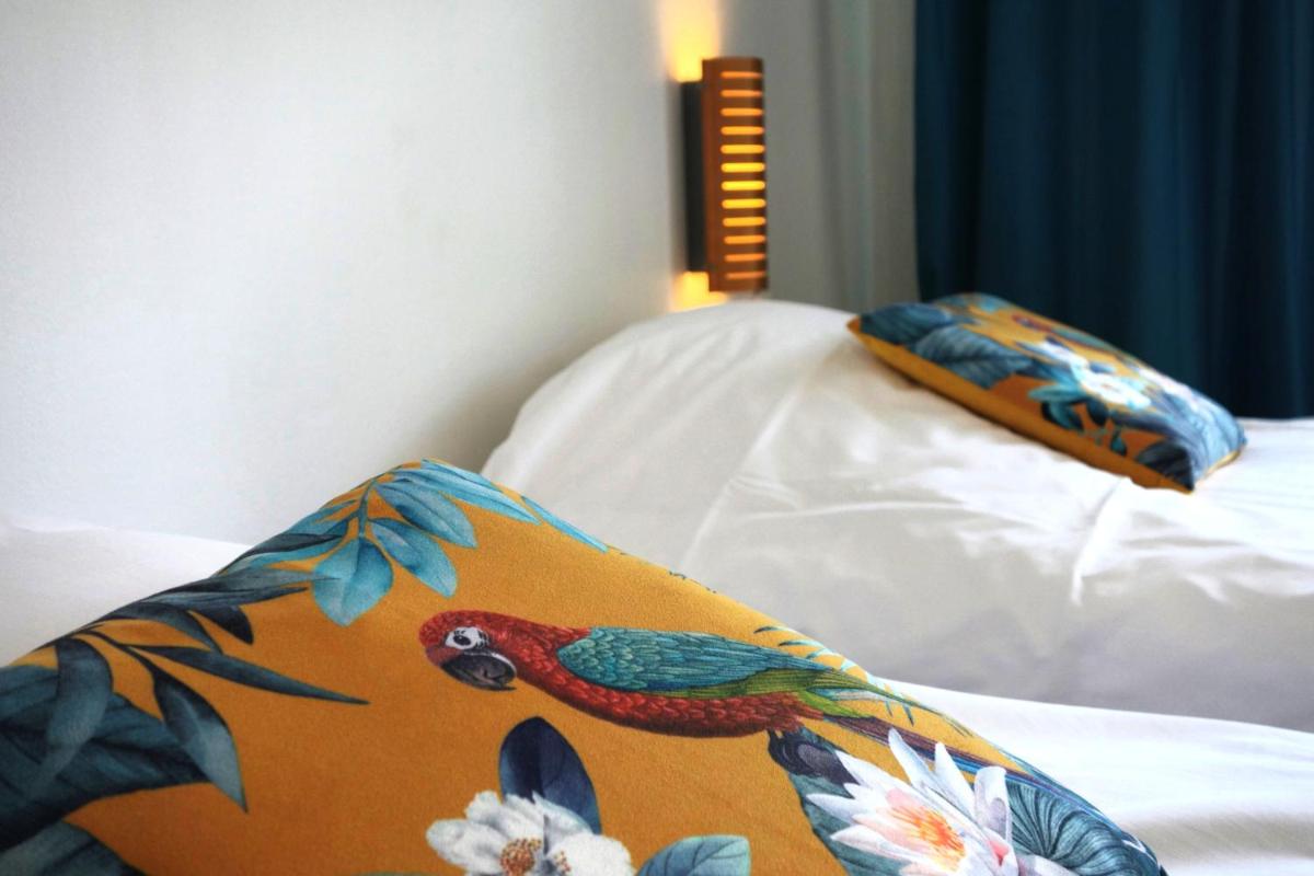 Un ou plusieurs lits dans un hébergement de l'établissement Hôtel La Ségalière Spa Bar