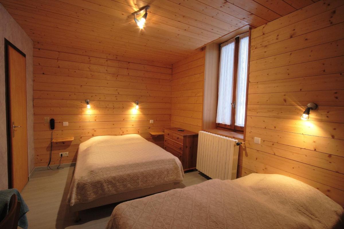 Un ou plusieurs lits dans un hébergement de l'établissement Logis Hotel & Spa Beau-Site