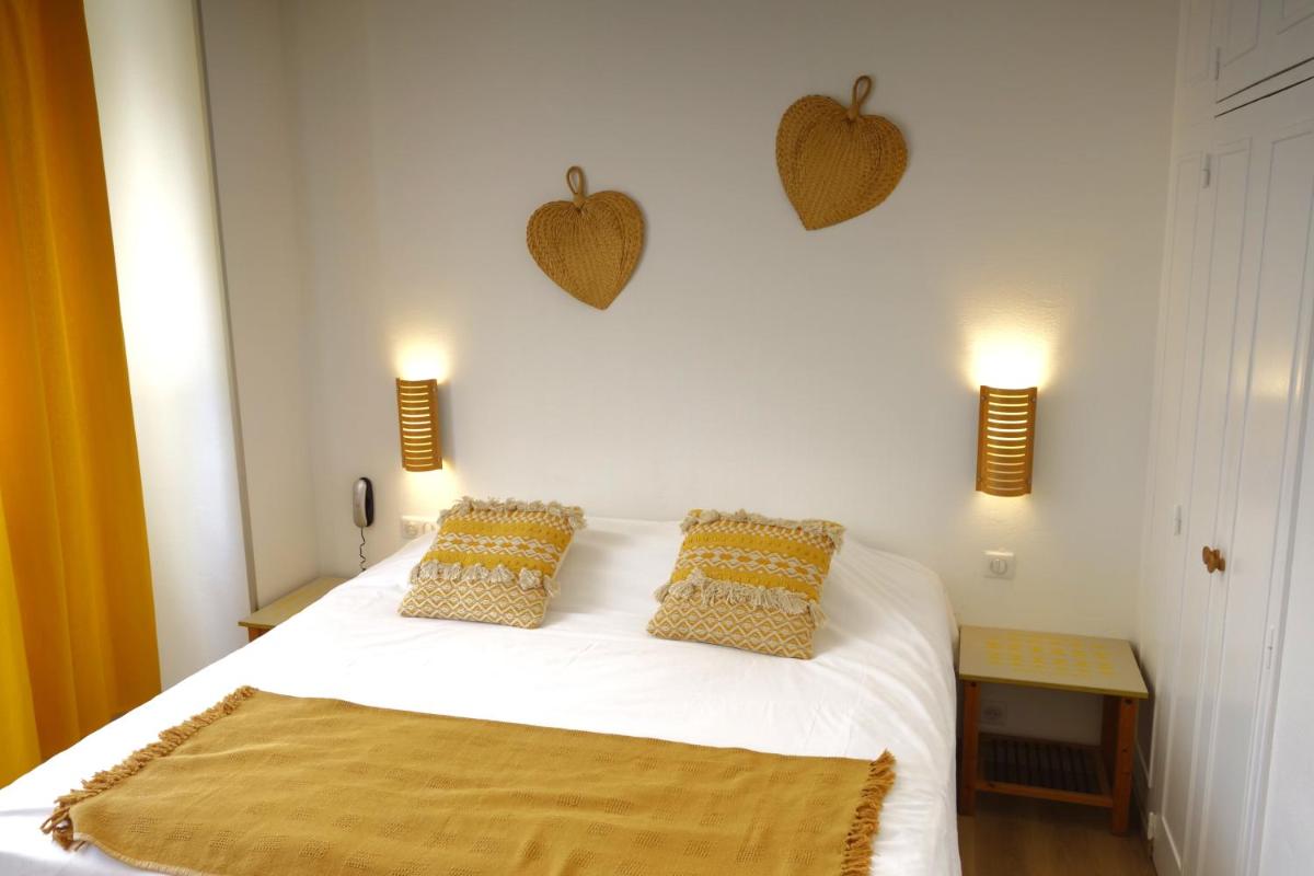 Un ou plusieurs lits dans un hébergement de l'établissement Hôtel La Ségalière Spa Bar
