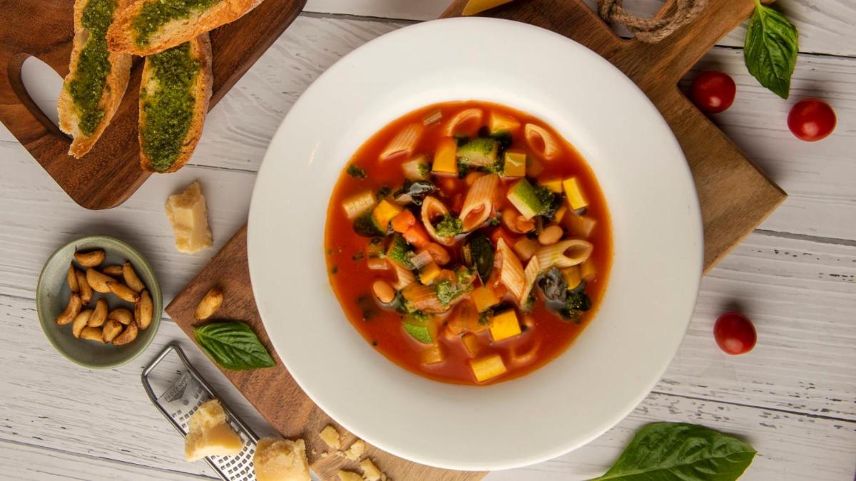 a bowl of pasta soup with vegetables and bread at Holiday Inn New Delhi Aerocity by IHG in New Delhi